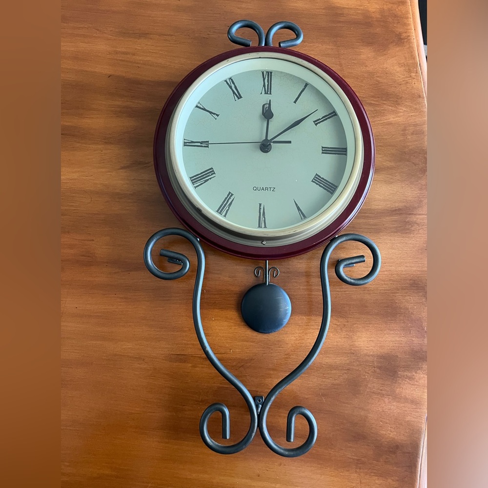Maroon colored wall clock. Battery operated.